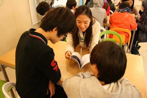 Sharing Page
A Harvard student (center) reads one of the Snowflake Stories to kids at Angel’s Haven orphanage.  Kirsty Taylor