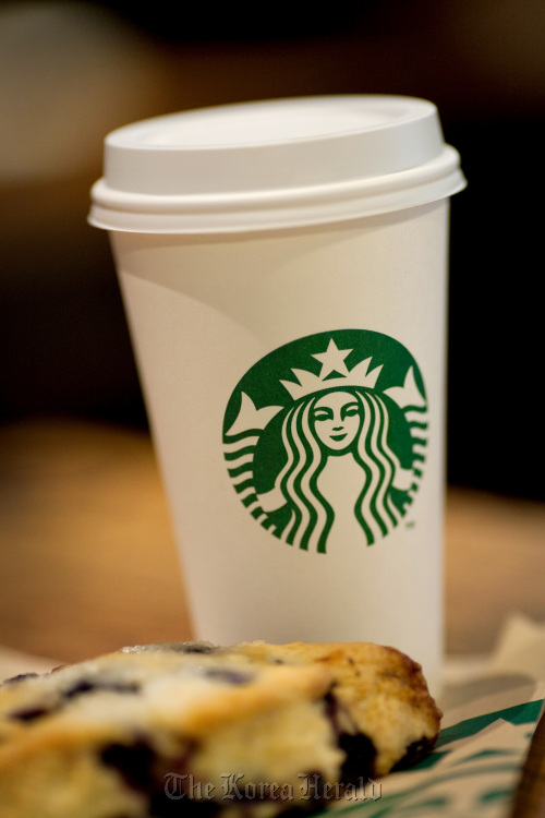 A large coffee sits on a table at a Starbucks coffee shop in Florham Park, New Jersey.   Bloomberg
