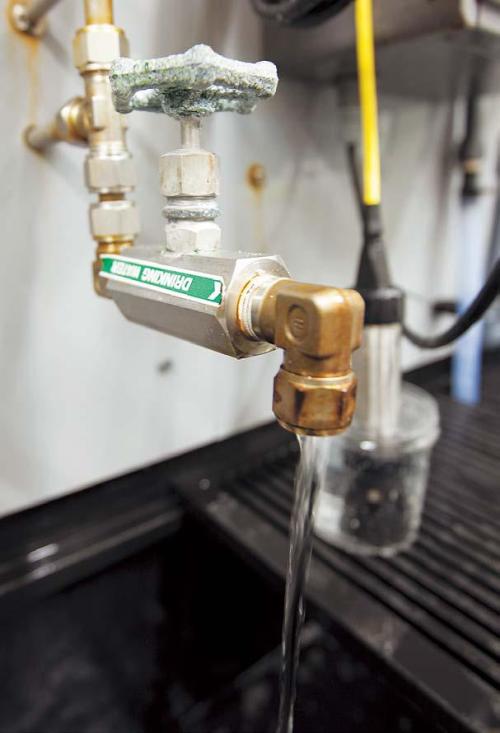 Treated water, ready to be added to the public water supply, flows from a tap in the laboratory at the Kurnell desalination plant in Sydney on Oct. 25, 2010. (Bloomberg)
