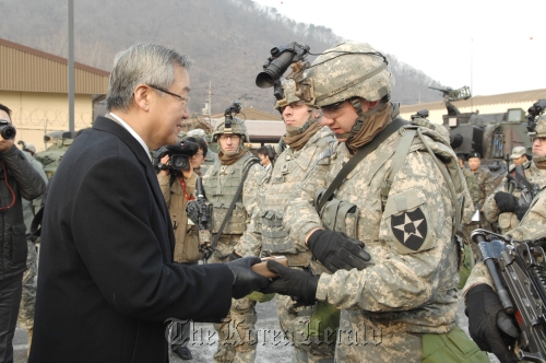 Minister of Foreign Affairs and Trade Kim Sung-hwan (left) hands a gift to a U.S. soliders at the U.S. Army’s 2nd Infantry Division in Dongducheon, 40 kilometers north of Seoul, on Friday.
Ministry of Foreign Affairs and Trade