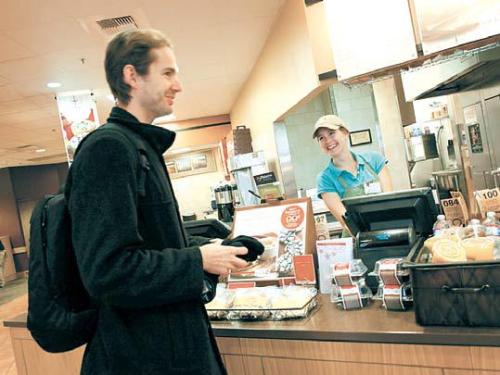 Lacey Walker (right) serves a customer at a Panera Bread Co.
restaurant in Burbank, California, on Dec. 12, 2011.
(Los Angeles Times/MCT)