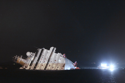 The luxury cruise ship Costa Concordia leans on its side after running aground the tiny Tuscan island of Giglio, Italy, Saturday. (AP-Yonhap News)