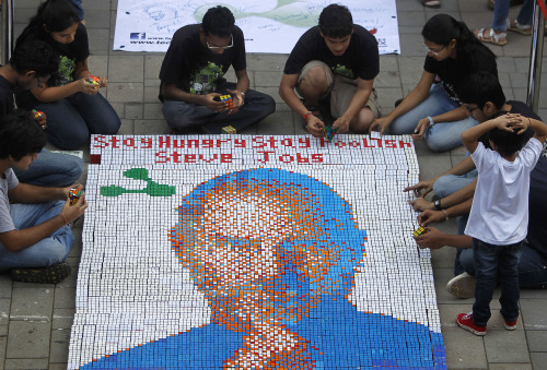 Students create a portrait of Apple Inc. legendary cofounder and chief executive Steve Jobs with Rubik's cubes in Mumbai, India, Friday. Students used over 1,500 Rubik's Cubes to create the portrait. (AP-Yonhap News)
