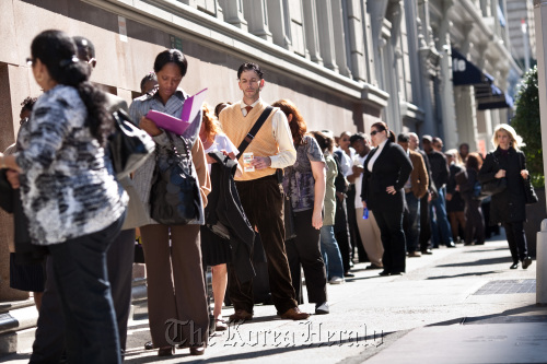 Job seekers wait on line outside the Metropolitan Pavilion before the start of a job fair in New York.   Bloomberg