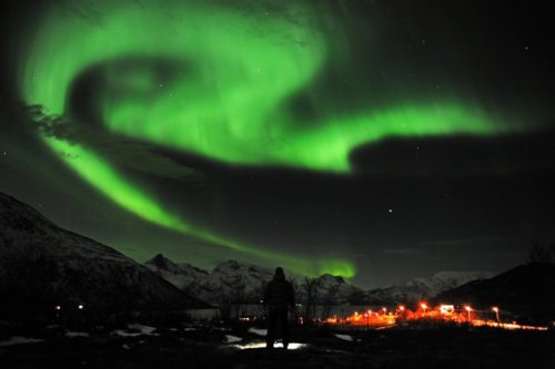 The aurora borealis, or Northern Lights, are seen near the city of Tromsoe, northern Norway, late Tuesday, Jan. 24, 2012. (AP)