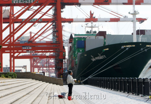 A man stands at a shipping terminal in Tokyo.  Bloomberg