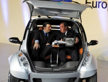 European Commission President Jose Manuel Barroso (left) and Spanish Chairman of Hiriko Jesus Echave sit in the rear of a Hiriko Citycar as they attend to "Global Launch of Hiriko Driving Mobility," a large scale European social innovation" on January 24, 2012 at EU headquarters in Brussels. (AFP)