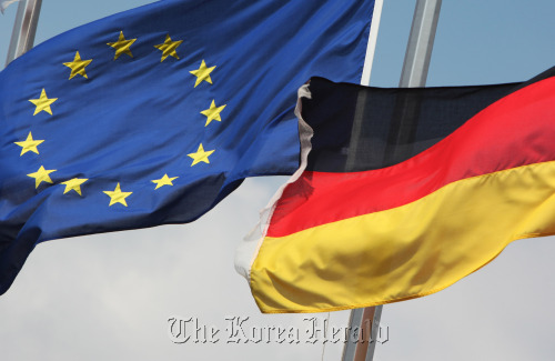 The European Union flag (left) flies next to Germany’s national flag at at City airport in London.  Bloomberg