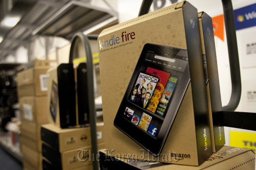 Boxes of the Amazon.com Inc. Kindle Fire tablet computer are stacked for purchase at a Best Buy Co. store in New York.  Bloomberg