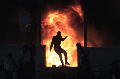 Flames rise from Cairo Stadium during the first half of a match between Zamalek and Ismaili clubs in Cairo on Wednesday. (AFP-Yonhap News)