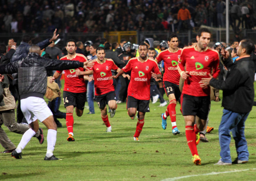 Team players of the Egyptian Al-Ahly club run for safety during clashes in Port Said, Egypt on Wednesday. (AP-Yonhap News