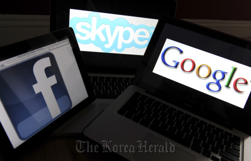 Skype Technologies SA, Facebook Inc., and Google Inc. logos are displayed on computer screens for a photograph.  Bloomberg
