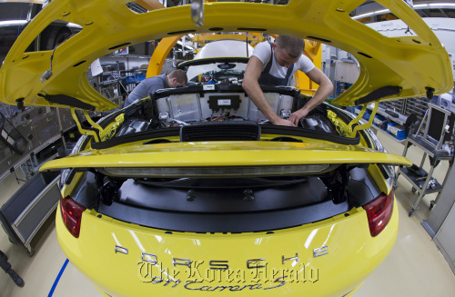 Employees work on a Porsche 911 Carrera S automobile as it travels along the production line inside the company’s factory in Stuttgart, Germany.  Bloomberg
Employees work on a Porsche 911 Carrera S automobile as it travels along the production line inside the company’s factory in Stuttgart, Germany.  Bloomberg
Employees work on a Porsche 911 Carrera S automobile as it travels along the production line inside the company’s factory in Stuttgart, Germany.  Bloomberg