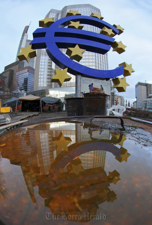 A Euro sign sculpture stands outside the European Central Bank’s headquarters in Frankfurt.  Bloomberg