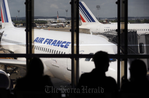 Passengers wait to board Air France flights at Orly Airport in Paris.  Bloomberg
Passengers wait to board Air France flights at Orly Airport in Paris.  Bloomberg