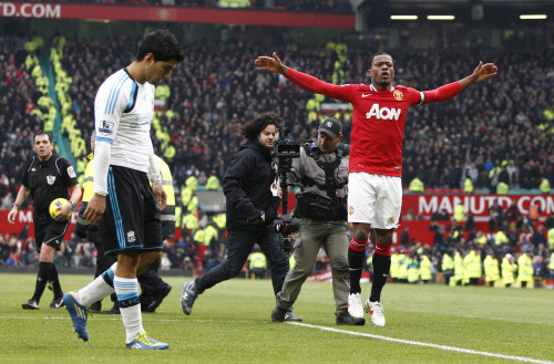 <YONHAP PHOTO-0023> Manchester United's Patrice Evra, right, celebrates alongside Liverpool's Luis Suarez after Manchester United's 2-1 win over their Merseyside rivals following their English Premier League soccer match at Old Trafford Stadium, Manchester, England, Saturday, Feb. 11, 2012. (AP Photo/Jon Super)/2012-02-12 00:07:52/ <저작권자 ⓒ 1980-2012 ㈜연합뉴스. 무단 전재 재배포 금지.>
Man United’s Patrice Evra (right) celebrates next to Liverpool’s Luis Suarez after the match.  AP-Yonhap News