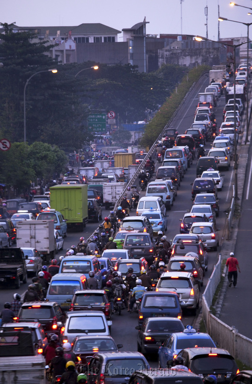 Indonesian drivers are caught in a traffic jam during rush hour in Jakarta.  Bloomberg