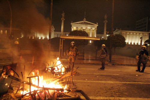 Fire is seen during clashes between protesters and riot police in central Athens Saturday. (Xinhua)