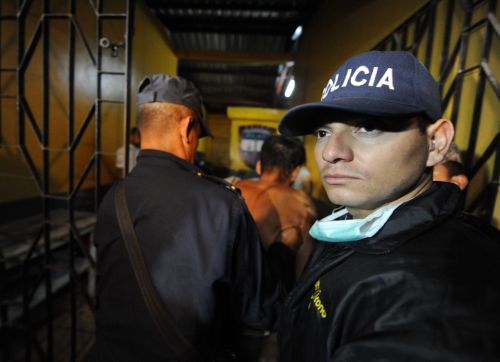 A surviving inmate is escorted out of the compound at the National Prison of Comayagua where at least 200 prisioners were killed and scores injured when fire tore through the prison in central Honduras, the Central American country's prisons director said. The prison held around 850 prisoners. (AFP-Yonhap News)