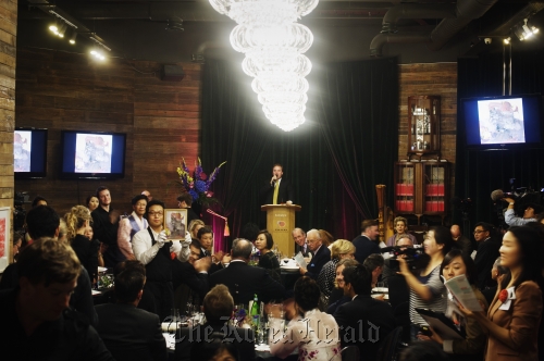 A charity auction takes place at the Korean Cultural Center in London in October 2010.  Korean Cultural Center in London