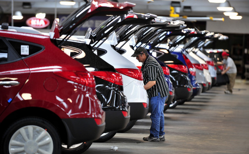 An employee installs a cargo mat on a 2012 Kia Motors Corp. Toucon sports utility vehicle (SUV) at the International Auto Processing Inc. (IAP) facility at Georgia Ports Authority Colonel's Island auto import and export terminal in Brunswick, Georgia, U.S., Monday, Feb. 27, 2012. Total vehicle sales data is scheduled to be released on March 1. Photographer: Stephen Morton/Bloomberg
An employee installs a cargo mat on a Kia Motors Corp. Tucson sports utility vehicle at the International Auto Processing Inc. facility at Georgia Ports Authority Colonel’s Island auto import and export terminal in Brunswick, Georgia, U.S., Monday.   Bloomberg
