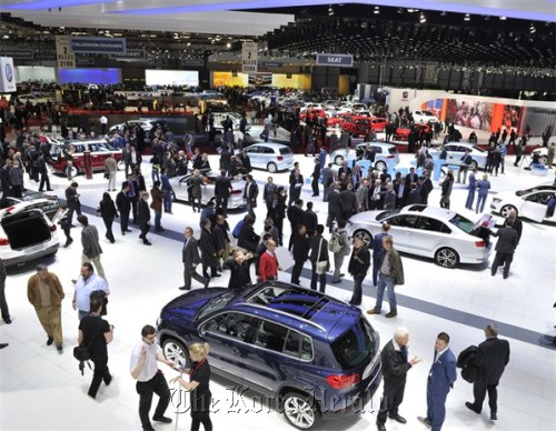 Visitors look at cars displayed at the 82nd Geneva International Motor Show that opened in the Swiss city on Tuesday. Hyundai Motor.