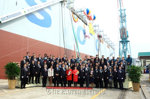 Hyundai Heavy Industries chief executive Lee Jai-seong (second from left, front row) and officials from the shipbuilder and its clients pose at a ceremony in Ulsan on Thursday to celebrate the company’s completion of 100 million gross tonnage of ships.  Hyundai Heavy Industries