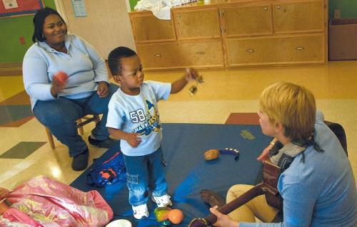 Music Therapist Bizzy Stewardson (front right) sings and plays with patient Joshua Washington (center), 2, and his mother Shamiko
Washington at Our Children’s House at Baylor in Dallas, Texas, on Nov. 11, 2011. (Dallas Morning News/MCT)