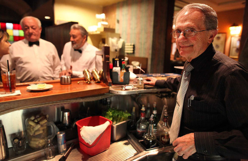 Bartender Fernando Gomez (right) and servers Jose Fragoso
and Bernard Inchauspe (left) have worked for decades at the
French restaurant Taix in Los Angeles, California’s Echo Park
neighborhood. (Los Angeles Times/MCT)