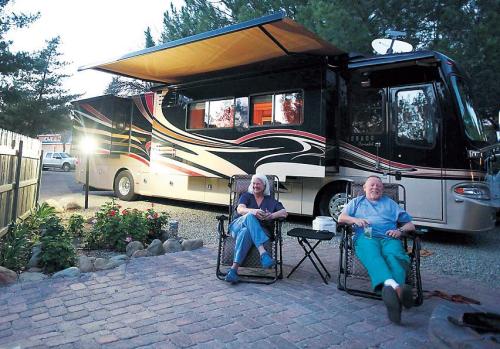 Mike (left) and Casey Venning of Napa, relax in front of their Monaco motor coach at Ventura Ranch, a KOA campground in Santa
Paula, California, Feb. 9.