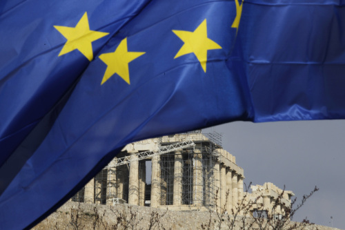 A European Union flag flies beneath the Parthenon temple on Acropolis hill in Athens on Wednesday. (Bloomberg)