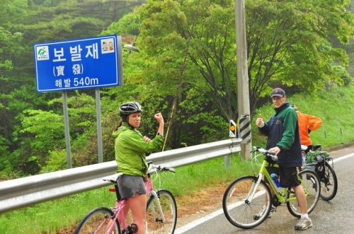 Andrew Godlewski and Suzanne Heibel pause on a Korean road during training for their Balkan bike-a-thon to aid North Korean kids.  Jared Mitchel