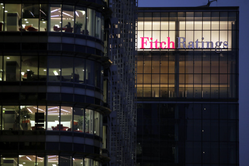 A sign for the financial agency Fitch Ratings Ltd., located within 30 North Colonnade, right, is seen on a building at the Canary Wharf business and shopping district in London, U.K., on Thursday, March 1, 2012. Moody뭩 Investors Service said Feb. 14 that Britain may lose its Aaa credit rating. Photographer: Matt Lloyd/Bloomberg
A sign for the financial agency Fitch Ratings Ltd. is seen on a building at the Canary Wharf business district in London.  Bloomberg