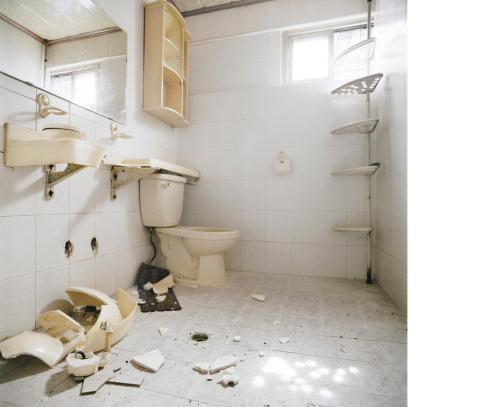 A photo from the “Zugzwang” series shows a sink that has been smashed by redevelopers in a house cleared for new apartment construction. Nils Clauss