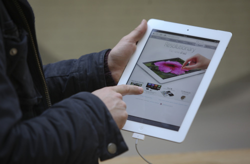A customer browses Apple Inc.'s new iPad tablet computer at the company's store in Covent Garden in London, U.K., on Friday, March 16, 2012. Apple Inc. started selling its new iPad today, betting on a sharper screen and faster chip to extend its lead over Google Inc. and Amazon.com Inc. in the growing market for tablet computers. Photographer: Chris Ratcliffe/Bloomberg
Apple Inc.’s new iPad tablet computer. Bloomberg