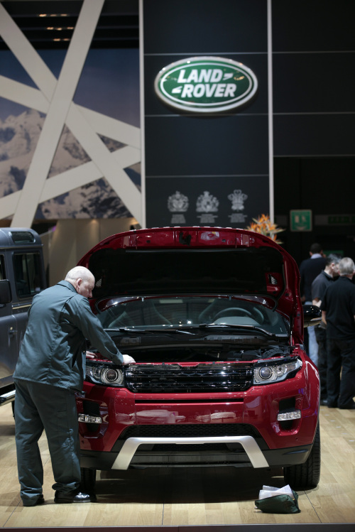 A man works to prepare the Range Rover Evoque, produced by Jaguar Land Rover Plc, ahead of the opening press day at the Geneva International Motor Show in Geneva, Switzerland, on Monday, March 5, 2012. The 82nd Geneva International Motor Show will showcase the latest models from the auto industry's leading manufacturers at the Palexpo exhibition centre this week. Photographer: Jason Alden/Bloomberg
A man prepares a Range Rover Evoque, produced by Jaguar Land Rover Plc, at the Geneva International Motor Show in Geneva on March 5.             Bloomberg