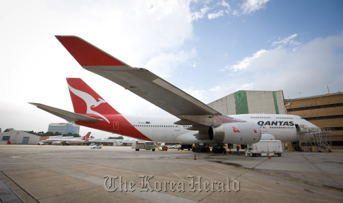 A Qantas Airways Ltd. Boeing Co. 747 aircraft stands in Sydney.  Bloomberg