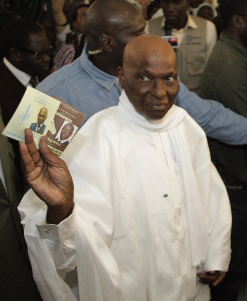 President Abdoulaye Wade holds up the ballot papers for himself and opponent Macky Sall as he prepares to cast his vote at a polling station in his home Point E neighborhood of Dakar, Senegal Sunday.