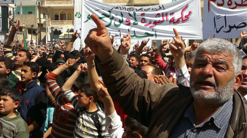In this citizen journalism image taken on Monday and provided by Edlib News Network ENN, anti-Syrian regime protesters shout slogans during a demonstration in Binish town in Idlib province, northern Syria. (AP-Yonhap News)