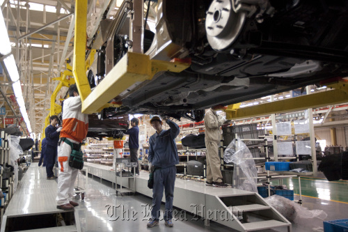 Employees work at Geely Automobile Holdings Ltd.’s factory in Cixi, Zhejiang Province, China.  Bloomberg