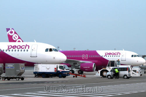 Airbus SAS A320 airplanes for Peach Aviation flights sit parked at Kansai International Airport in Osaka, Japan, on March 1.    Bloomberg