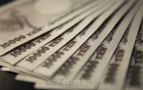 Japanese 10000 yen notes are displayed for a photograph in Tokyo.  Bloomberg