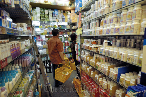 Shoppers browse through the aisles of medicines and health supplements at a pharmacy in China.
Bloomberg
Shoppers browse through the aisles of medicines and health supplements at a pharmacy in China.
Bloomberg