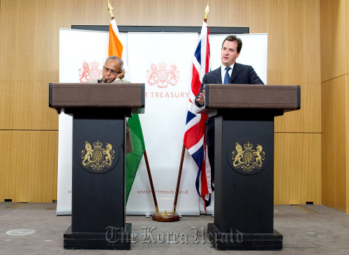 George Osborne (right), U.K. chancellor of the exchequer, speaks as Pranab Mukherjee, India’s finance minister, listens during their joint news conference at the Foreign and Commonwealth Office in London last year.  Bloomberg