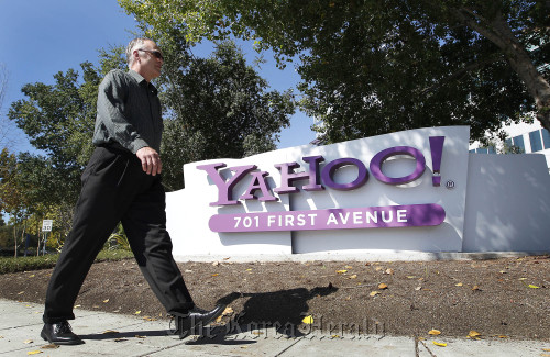 A pedestrian walks past Yahoo! Inc. signage displayed outside of company headquarters in Sunnyvale, California.  Bloomberg