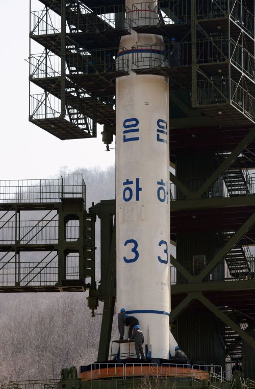 North Korean technicians check the Unha-3 rocket at Tangachai -ri space center on Sunday. (AFP-Yonhap News)