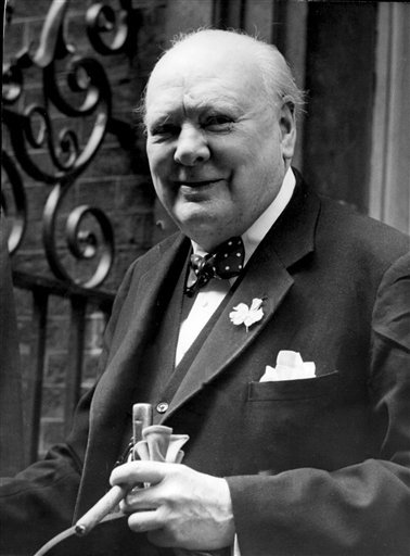 In this June 24, 1952, file photo, Sir Winston Churchill smiles at the front door of 10 Downing Street, London.    AP