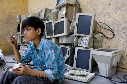 Discarded computer monitors are stacked in a recycling garage.
Bloomberg