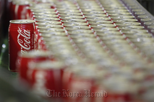 Coca-Cola cans move along the production line of Sendai Coca-Cola Products Co.’s Zao plant in Zao town, Miyagi prefecture, Japan.  Bloomberg