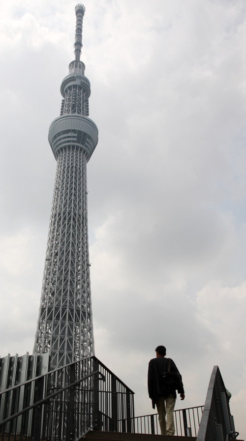 A man walks toward the Tokyo Sky Tree in Tokyo, Japan, on Tuesday, April 17, 2012. The broadcasting tower which is the tallest structure in Japan at 634 meters, opens to the public on May 22. Photographer: Tomohiro Ohsumi/Bloomberg
A man walks toward the Tokyo Skytree in Tokyo on Tuesday.   Bloomberg